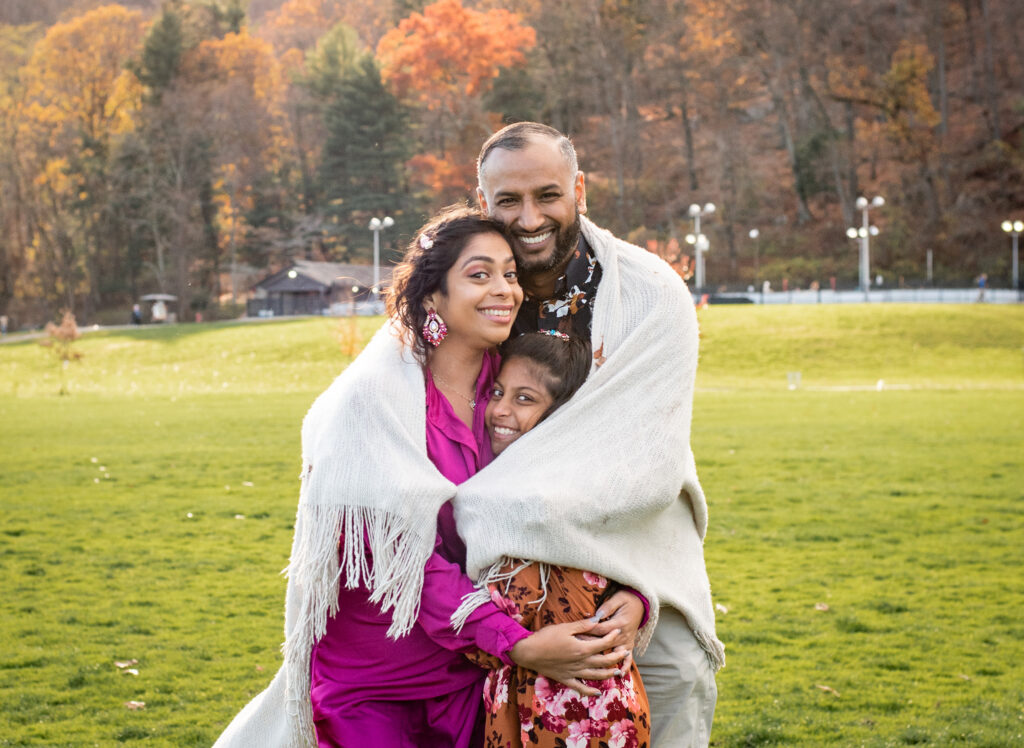 Bloomfield family photographer, family hugging in park
